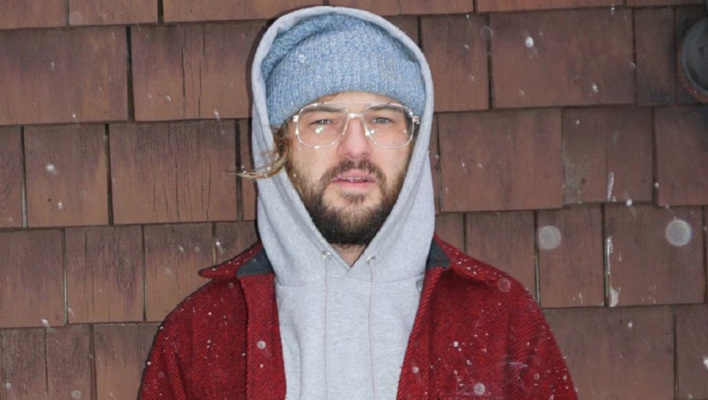 Ryley Walker | Course in Fable Ryley Walker album art. Singer-songwriter in beanie, hoodie, and red jacket. April 2021 music roundup.