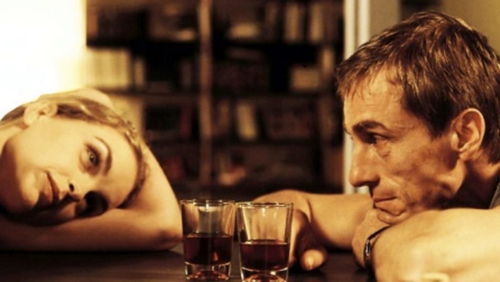 Something to Remind Me | Christian Petzold Couple at bar with drinks. Man and woman in contemplation, relationship issues.