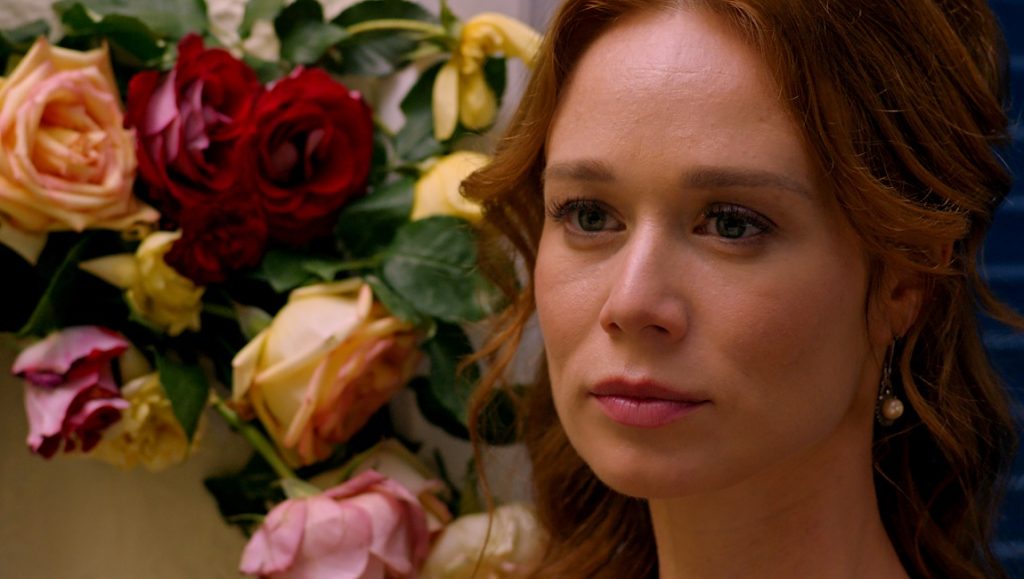 Capitu and the Chapter | Júlio Bressane Capitu and the Chapter film still. Portrait of a woman with red hair and flowers.