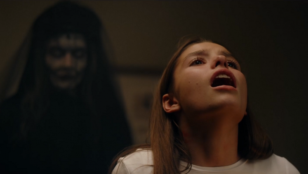 Before We Vanish | June 2021: Queen of Spades, Sublet, The Evil Next Door Scared girl with the Queen of Spades horror figure behind her. Dark movie scene.