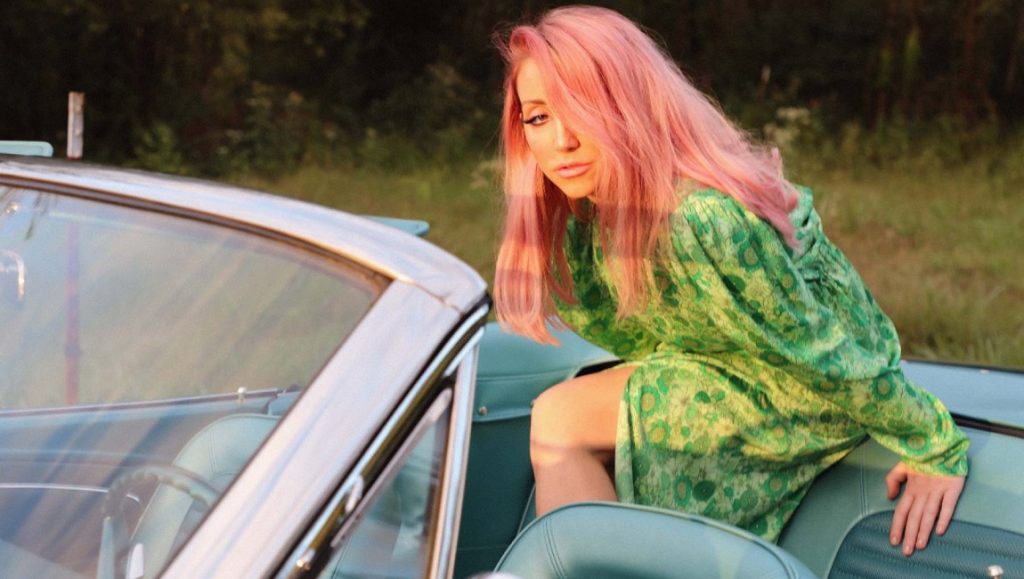 Ashley Monroe | Rosegold Ashley Monroe in a vintage convertible. Singer with pink hair wearing a green dress. Country music artist.