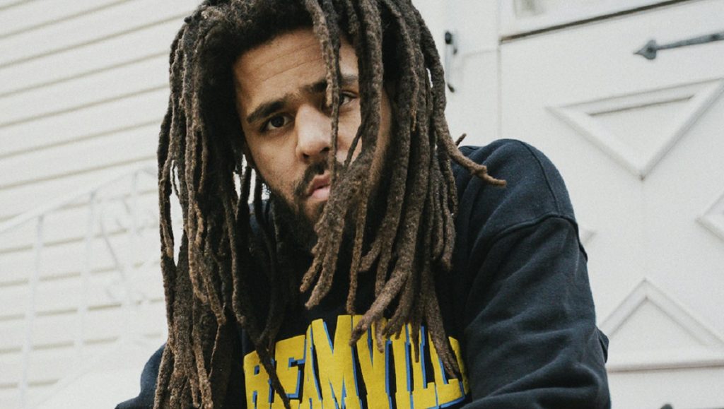 Album Roundup — May 2021 | Part 1: J. Cole, Miranda Lambert, Chai J. Cole album review. Portrait of J. Cole with dreadlocks, wearing a black hoodie. May 2021 album roundup.