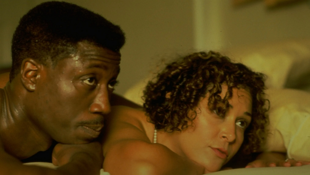 Jungle Fever movie still. Wesley Snipes and Annabella Sciorra in a scene. Spike Lee film.