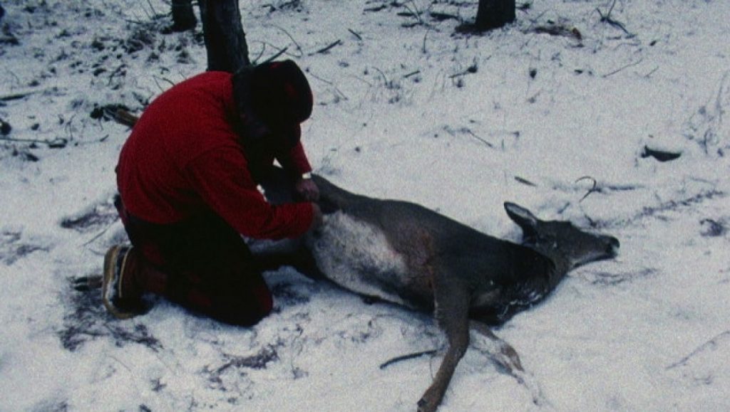 Landscape Suicide | James Benning Landscape Suicide still: Man with deer in snowy woods. James Benning film scene.