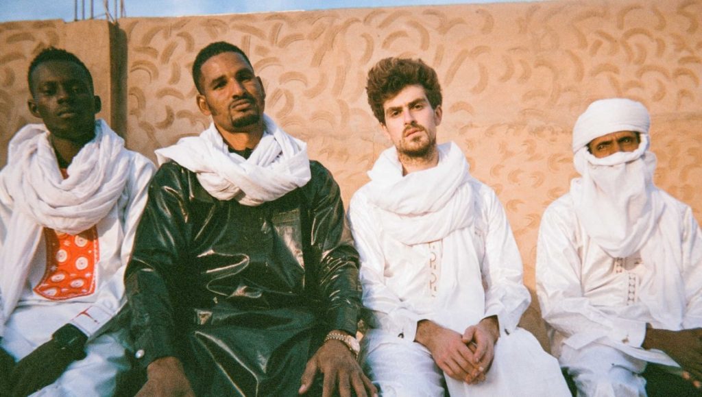Mdou Moctar | Afrique Victime Mdou Moctar band members in May 2021 press photo. Group portrait of musicians in traditional clothing. Album roundup.