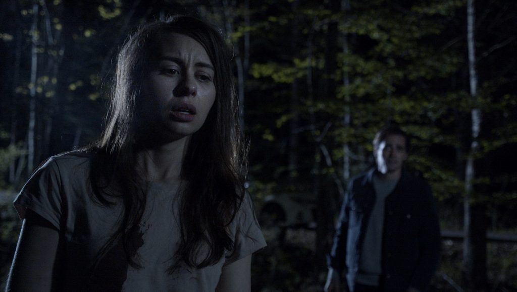 An Unquiet Grave | Terence Krey An Unquiet Grave movie scene. Woman in distress, man in background. Horror film.