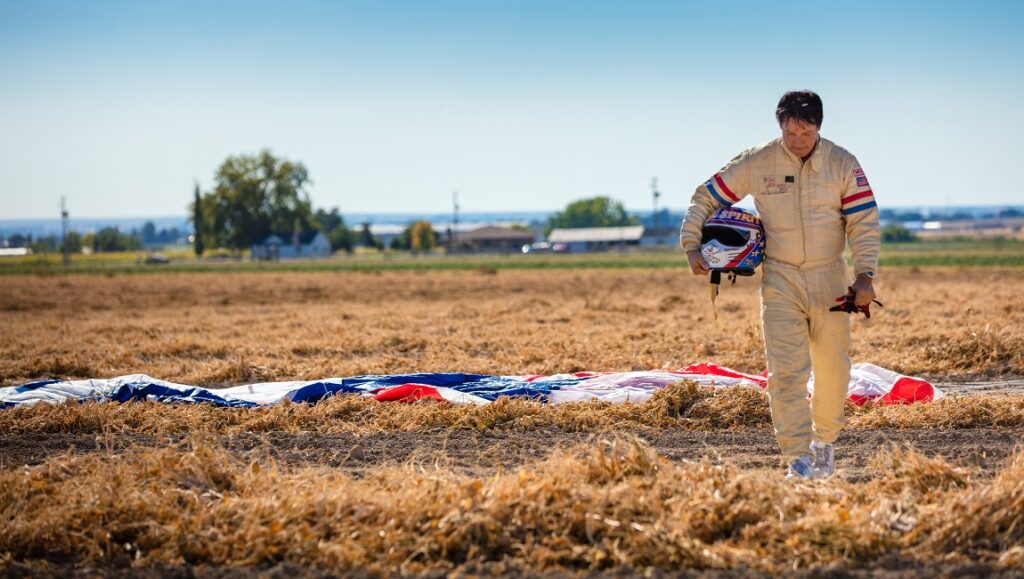 Stuntman | Kurt Mattila Stuntman Kurt Mattila after a parachute jump. Man in jumpsuit holding helmet.