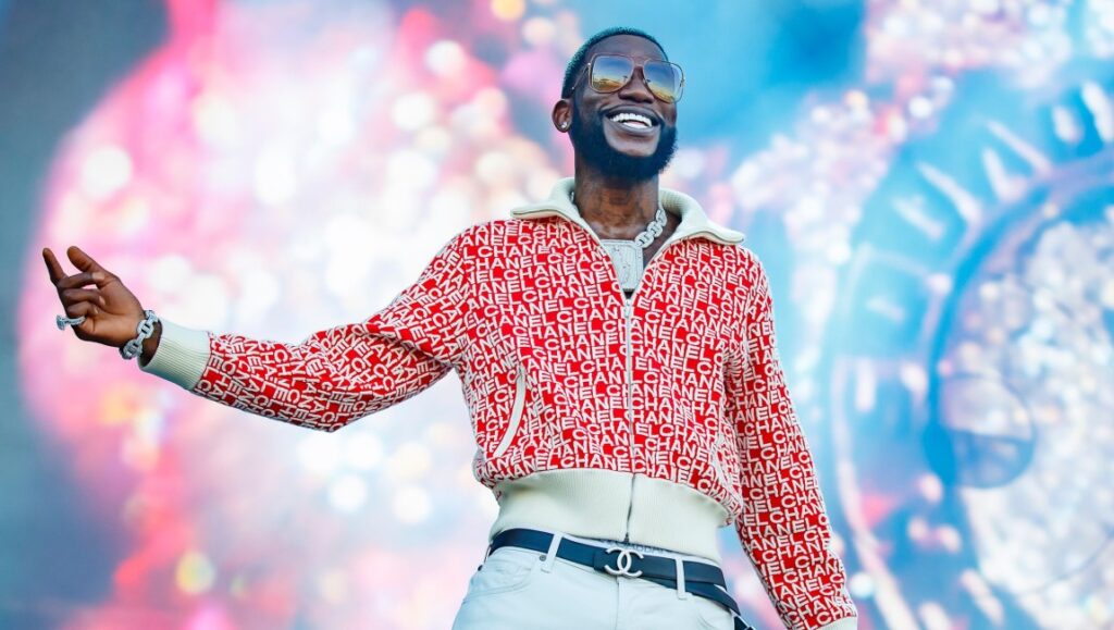 Gucci Mane | Ice Daddy Gucci Mane performs in June 2021. Rapper wears Chanel jacket, sunglasses, and jewelry. Album roundup.
