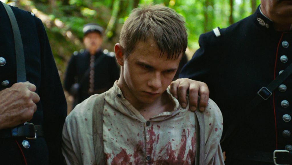 Bruno Reidal, Confession of a Murderer | Vincent Le Port Bruno Reidal still. Young man, bloodied, with soldiers. Clara Sola film image. Nathalie Álvarez Mesén movie.