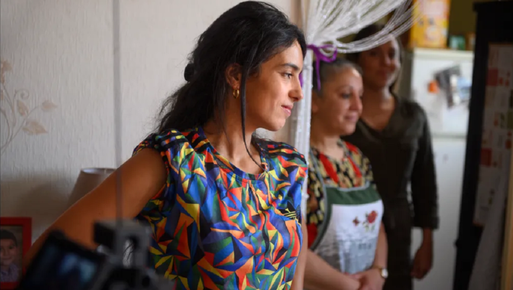 A scene from The Good Mother at Cannes Film Festival 2021. Three women stand indoors.