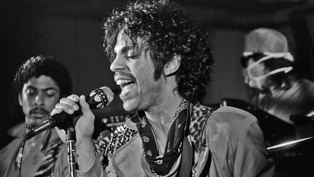 Black and white shot of Prince performing live during the Controversy era.