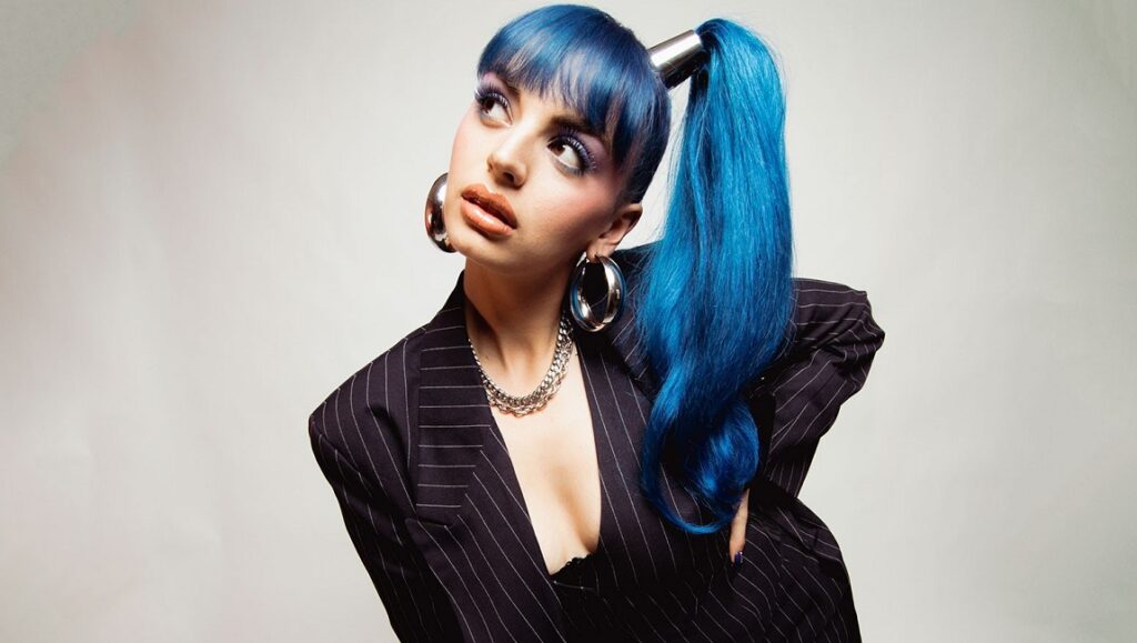 Rebecca Black | Rebecca Black Was Here Faye Webster inspired look. Woman with blue hair, pinstripe blazer, and hoop earrings. I Know I'm Funny haha.