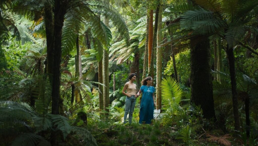 Sycorax film still, Cannes Film Festival. Two women stand in a lush, green forest. Indie film, The Braves, Cannes 2021.