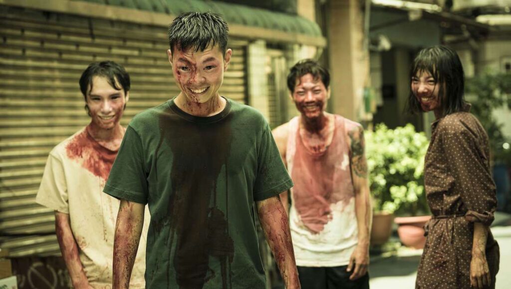 The Sadness — Rob Jabbaz The Sadness movie scene. Blood-covered people smiling. Horror film. Zombie-like figures. Taiwanese horror film. Gore.