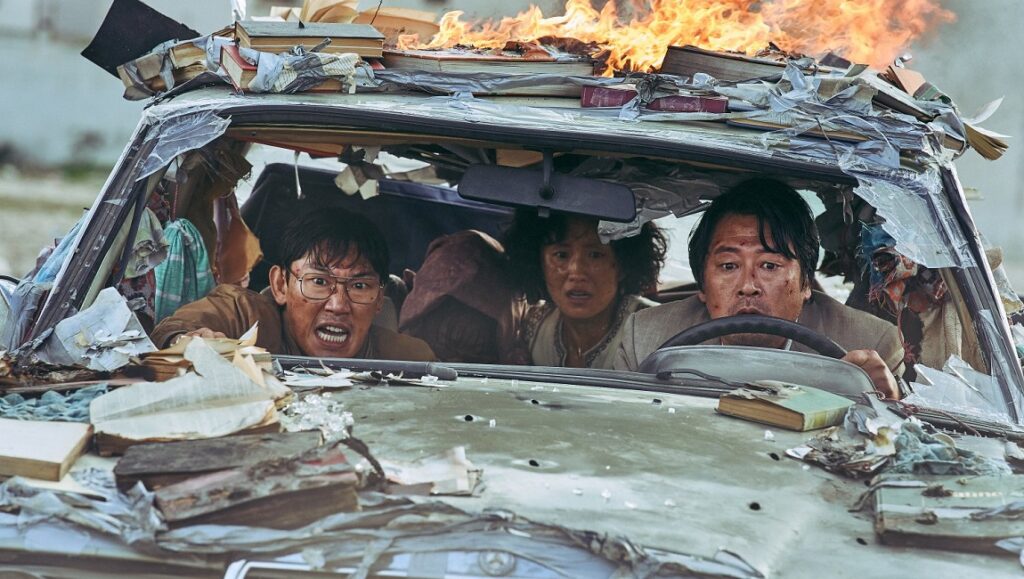 Escape from Mogadishu movie scene. People in a car covered with books and on fire, escaping danger.