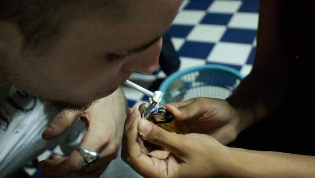 Lost Boys | Joonas Neuvonen Still from Lost Boys at Fantasia Fest. Man smoking, lighter in hand. Film still.