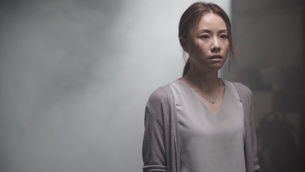 Shadows | Glenn Chan Glenn Chan's Shadows series: Woman in gray cardigan, looking concerned in a shadowy scene.