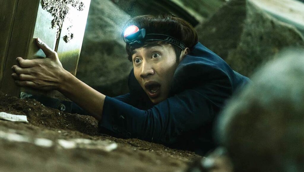 Man in Sinkhole movie with headlamp, looking shocked. NYAFF 2021 film.
