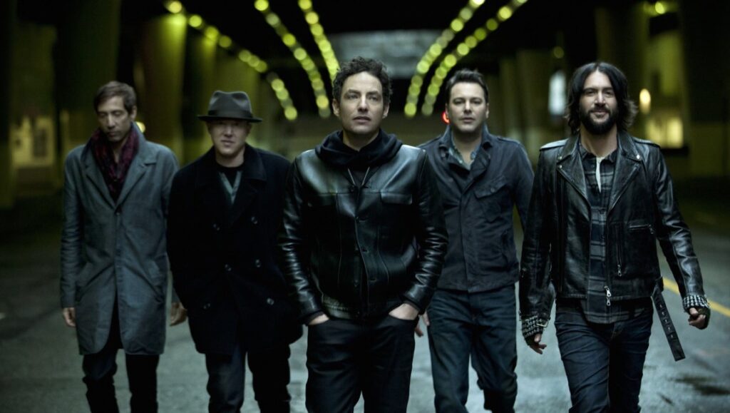 The Wallflowers | Exit Wounds The Wallflowers band. Album Roundup July 2021. Group shot of the band members in jackets and coats.