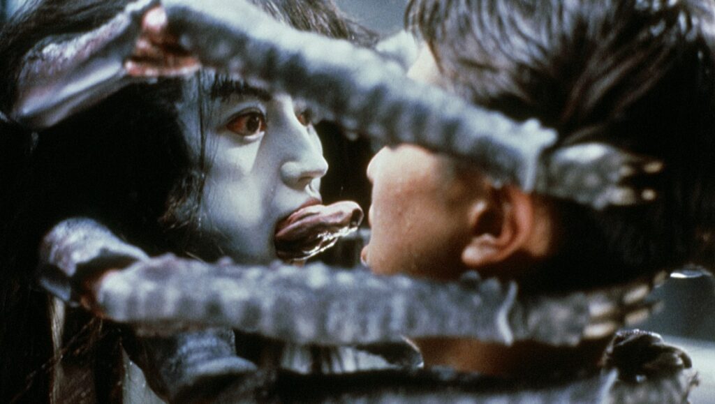 Hiruko the Goblin film still. Goblin with extended tongue faces a child. Japan Cuts 2021 film festival.