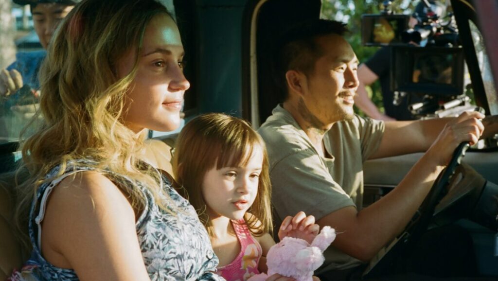 Blue Bayou movie image: Justin Chon drives with his wife and daughter in a truck. Family portrait.