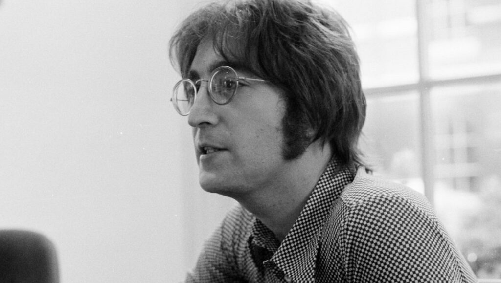 John Lennon in black and white, wearing round glasses. Imagine.