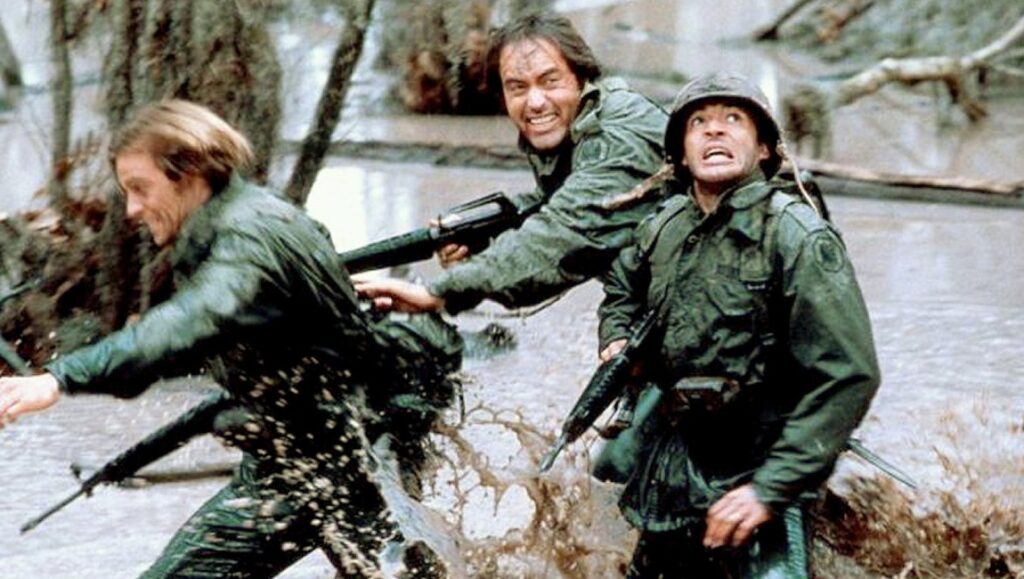 Southern Comfort movie scene. Soldiers in swamp, armed with rifles, running with fearful expressions. Walter Hill film.