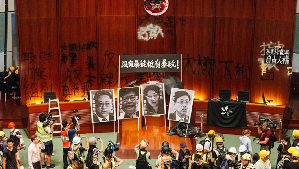 Hong Kong Legislative Council chamber under occupation. Vandalism, graffiti, and portraits displayed. CineCina Film Festival 2021.