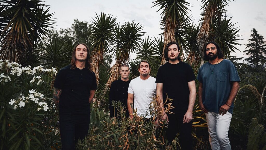 Deafheaven band portrait. Group of five members outdoors with plants. August 2021 album roundup.