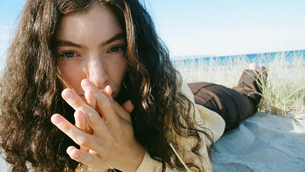 Lorde lying on a beach. New music album review: Solar Power. August 2021.