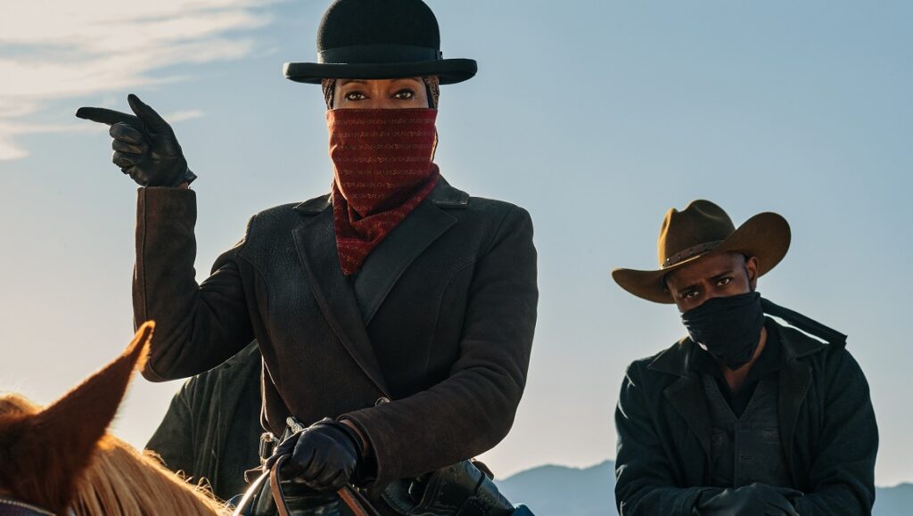 The Harder They Fall movie still. Regina King and Idris Elba as Rufus Buck Gang members.