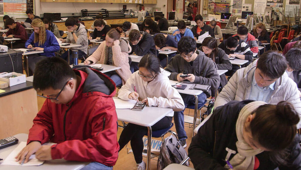 Try Harder! | Debbie Lum Try Harder! film still. Students in a classroom use calculators during an exam. DOC NYC 2021.
