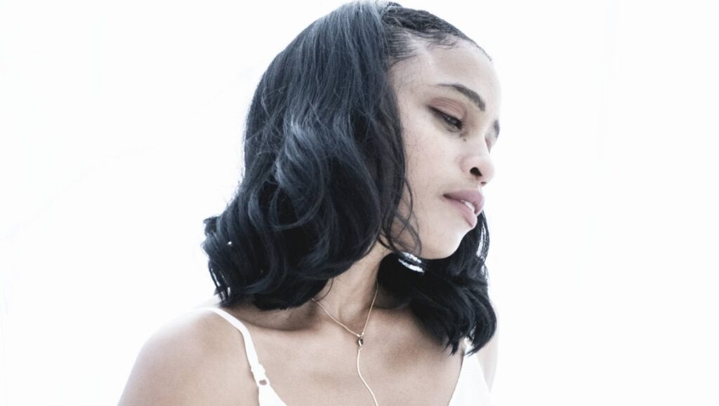 Adia Victoria, September 2021 album. Portrait of the singer with black hair and a gold necklace.