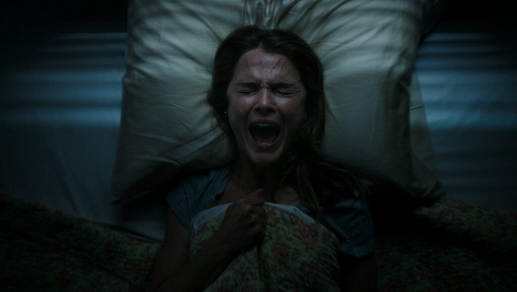 Antlers | Scott Cooper Antlers movie scene: Keri Russell screams in terror while lying in bed. Horror movie.