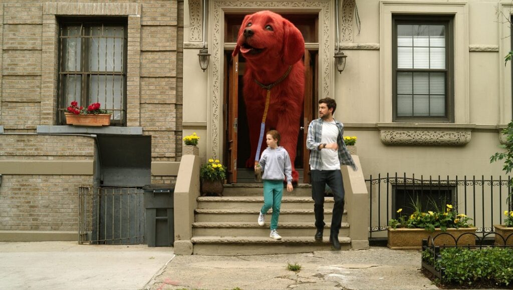Clifford the Big Red Dog | Walt Becker Clifford the Big Red Dog movie scene. Girl and man walk with giant red dog from a brownstone building.