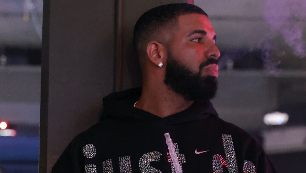 Drake in September 2021 album roundup. Rapper in Just Do It hoodie smokes. New music.