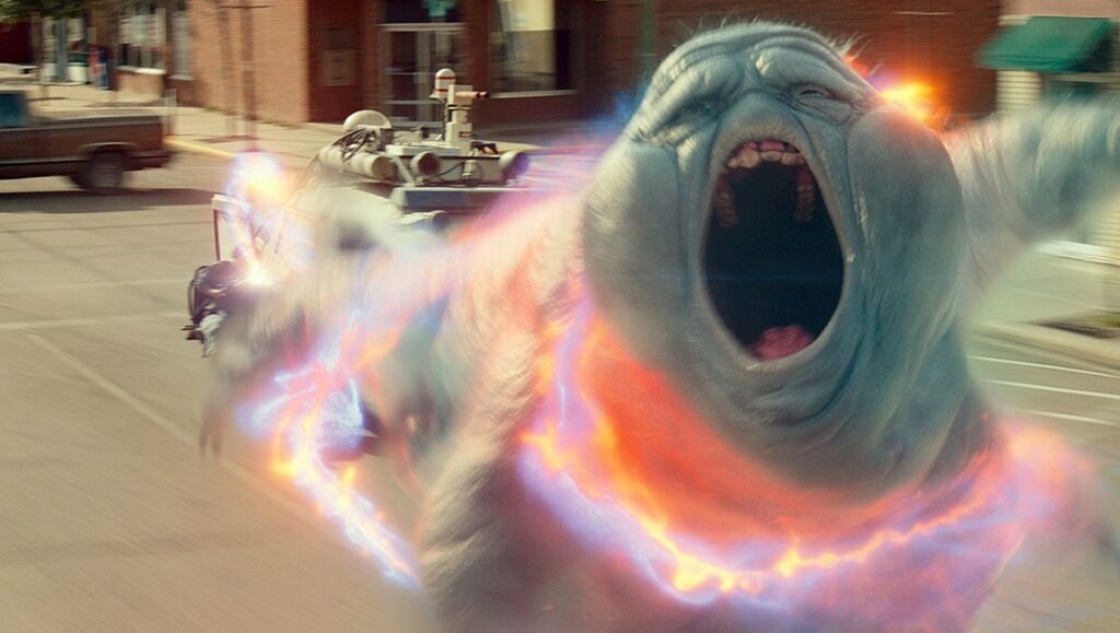 Slimer in Ghostbusters: Afterlife movie. Ghostly apparition with open mouth and proton beams.