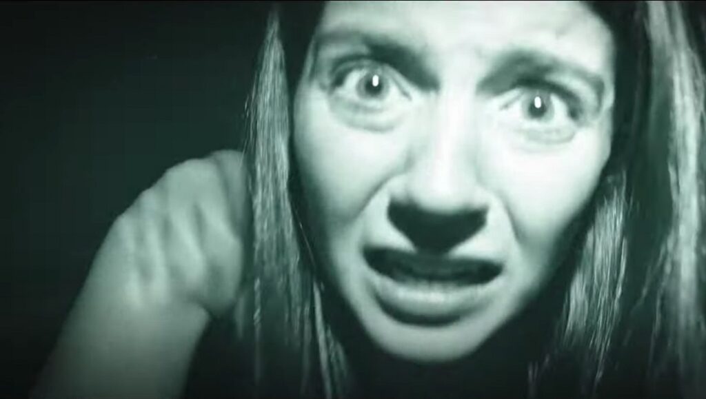 Paranormal Activity: Next of Kin | William Eubank Terrified woman in Paranormal Activity: Next of Kin. Horror movie scene with a scared expression. William Eubank film.