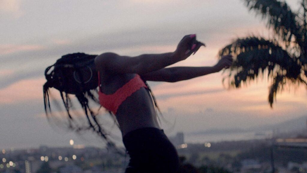 Woman with braids dancing at dusk. Isolation, Before We Vanish November 2021.