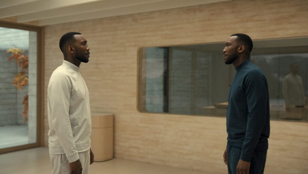 Swan Song | Benjamin Cleary Mahershala Ali in Swan Song. Two versions of the same man face each other in a minimalist, modern setting.