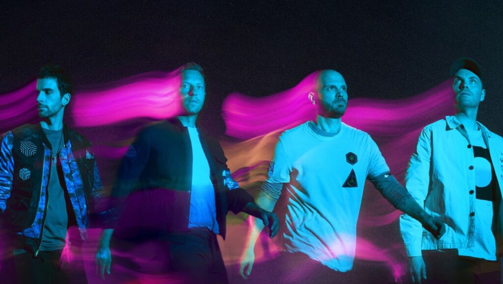 Coldplay band portrait. Group shot with colorful light trails. Music band promo image.