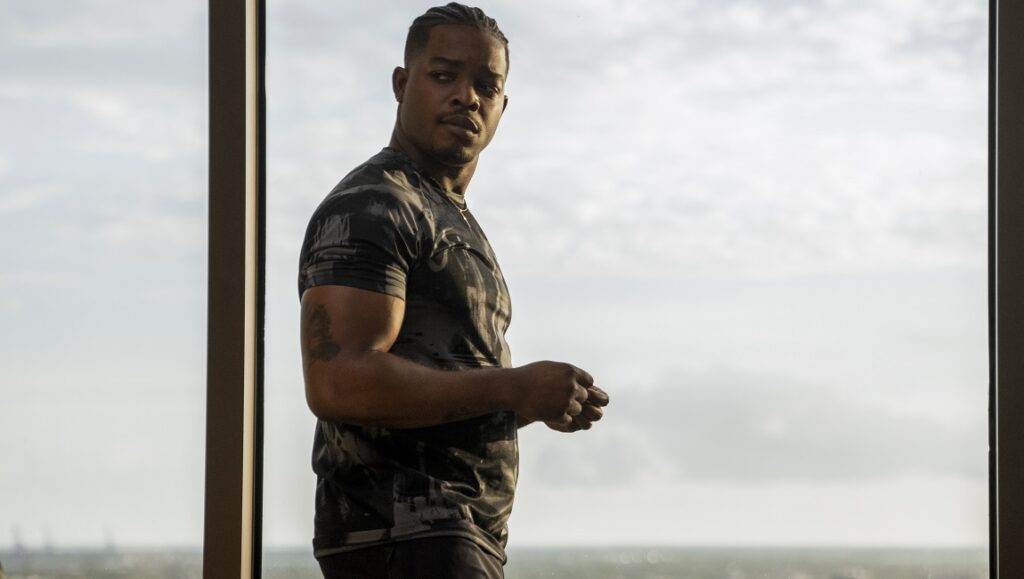 National Champions | Ric Roman Waugh Stephan James in National Champions movie. James, as a football player, looks out a window.