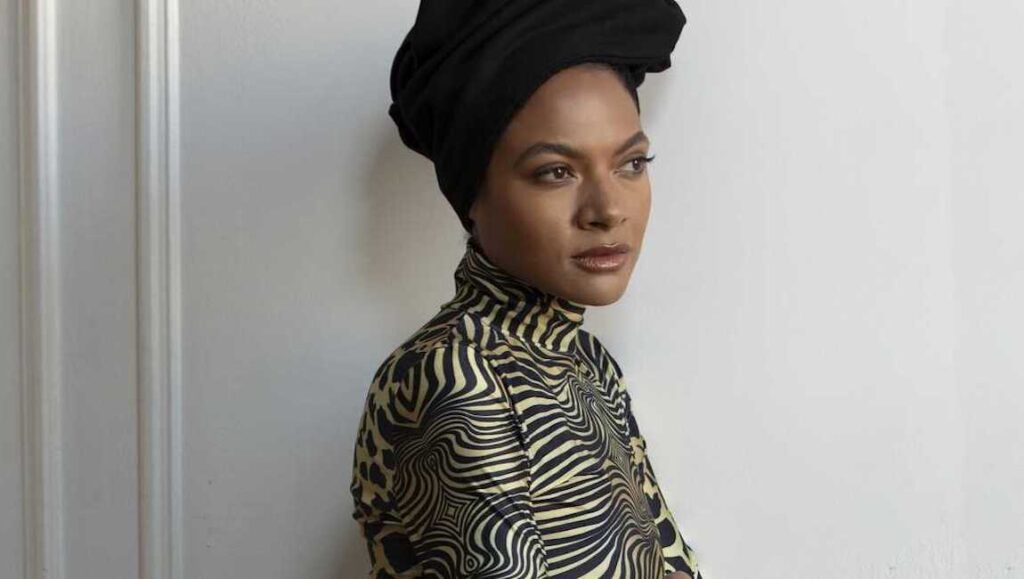 Best Albums of 2021: Allison Russell | Outside Child Allison Russell, top album of 2021. Portrait of the singer with a black head wrap and patterned top.