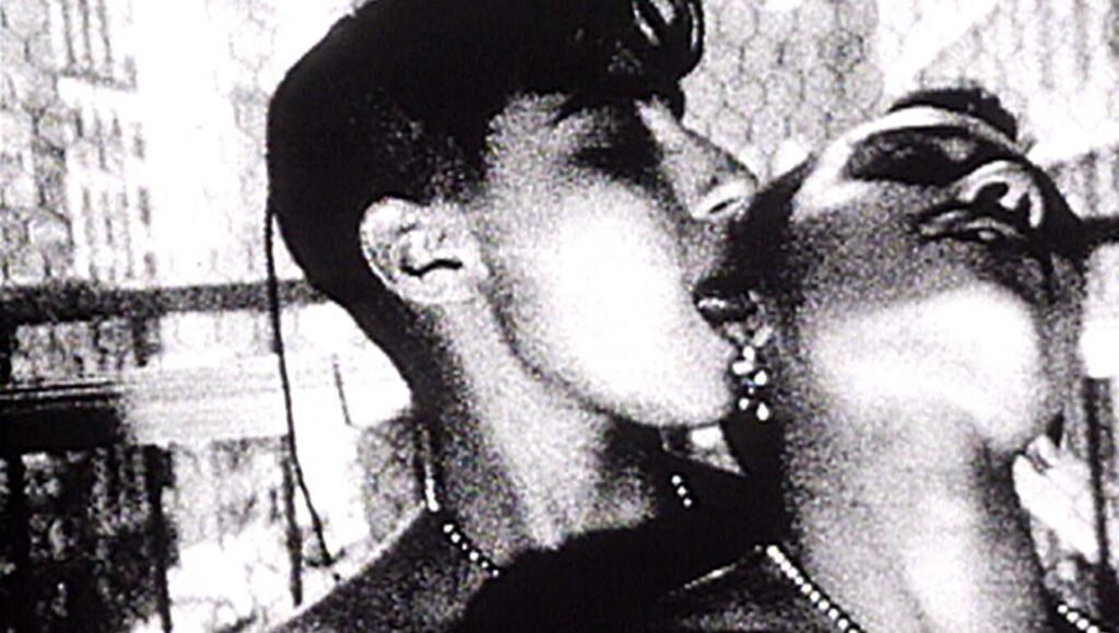 Nitrate Kisses — Barbara Hammer Black and white still from Barbara Hammer's Nitrate Kisses, showing two women kissing.
