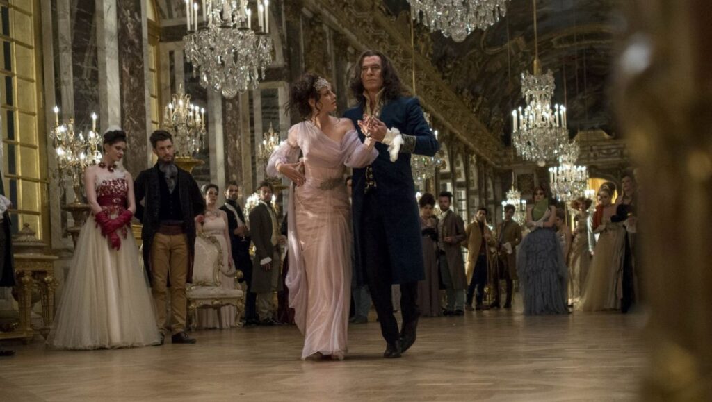Before We Vanish — January 2022: The King’s Daughter, The Tiger Rising, The Free Fall The King's Daughter movie scene. Ballroom dance with chandeliers. Kaya Scodelario, Pierce Brosnan.