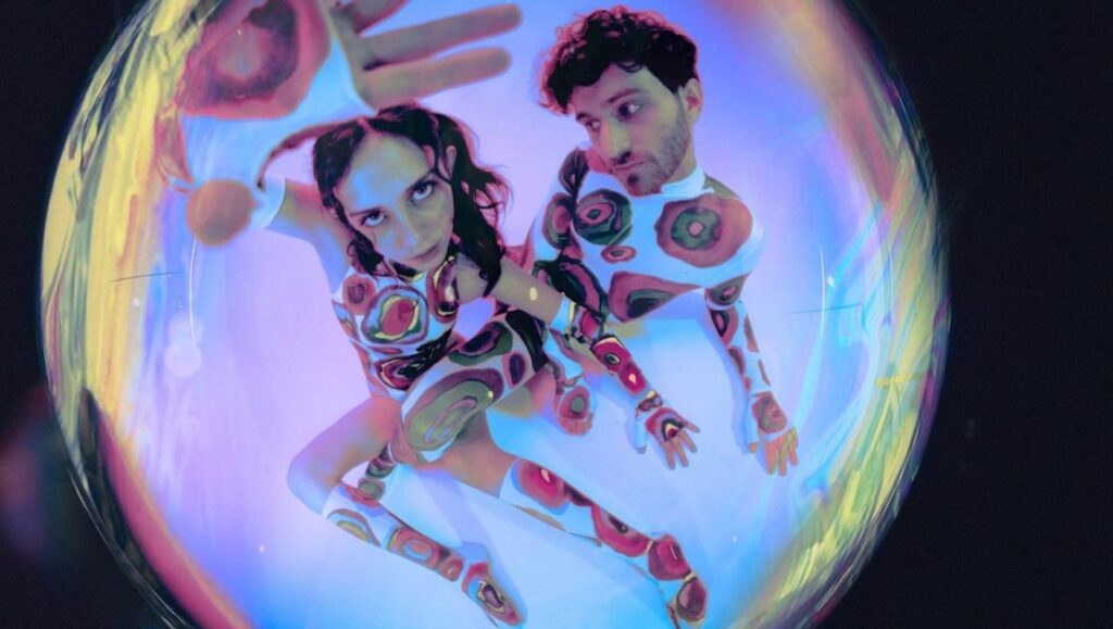 Best Albums of 2021: Magdalena Bay | Mercurial World Magdalena Bay album art. Duo in patterned outfits inside a bubble. Top 2021 albums. Indie pop music.