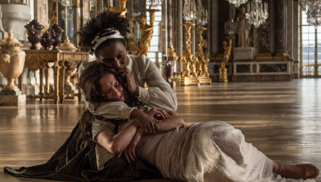 The King’s Daughter — Sean McNamara The King's Daughter movie scene. Woman comforting crying woman on floor.
