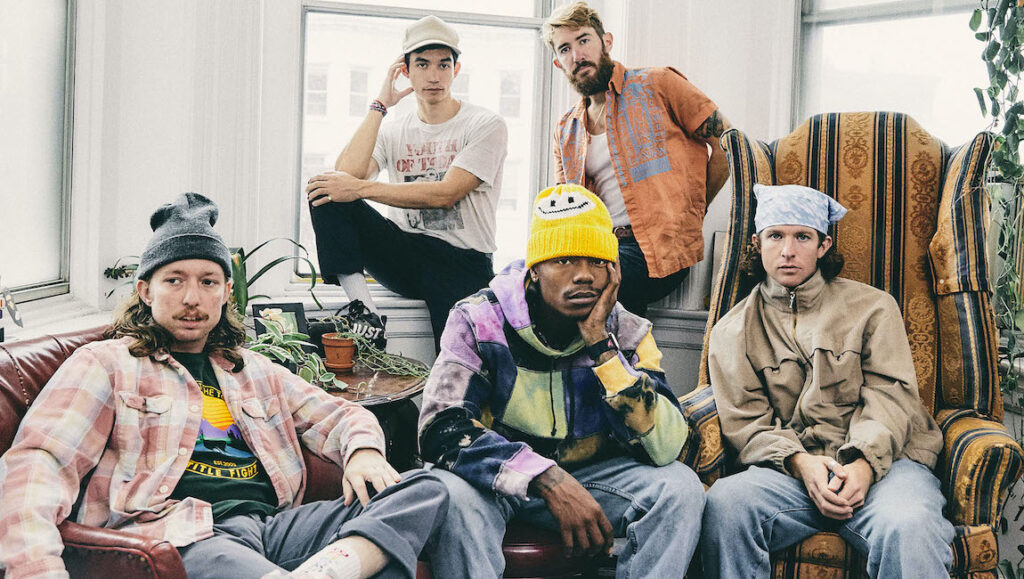 Best Albums of 2021: Turnstile | GLOW ON Turnstile, top album of 2021. Band portrait with members in beanies, hats, and casual clothing. Indie music group.