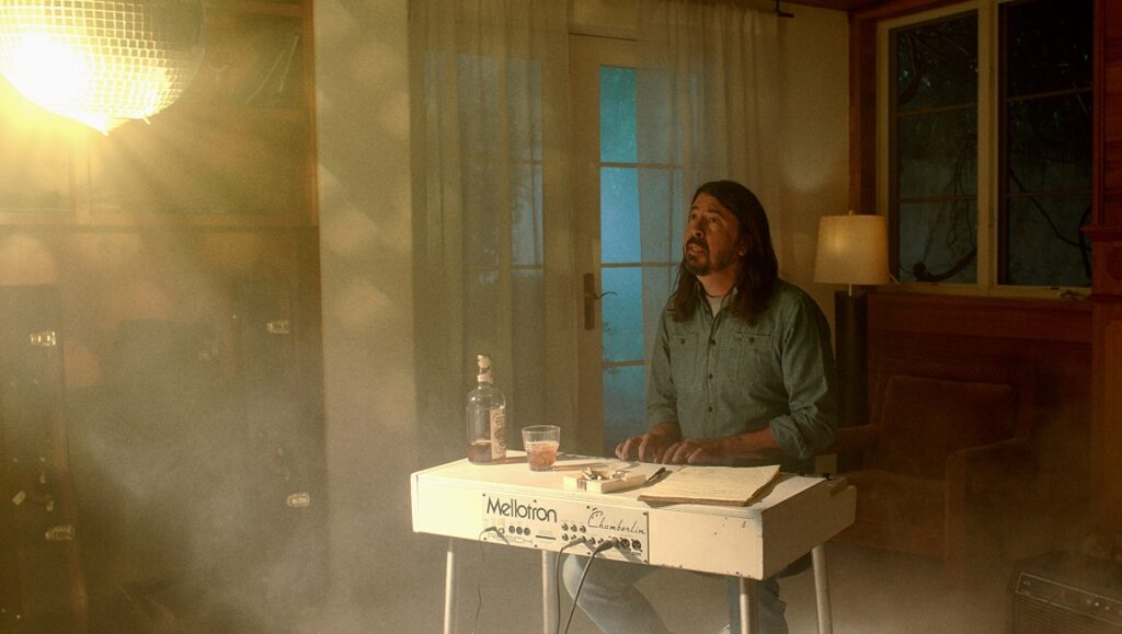Dave Grohl plays Mellotron in Studio 666 movie. Bottle, glass, ashtray on keyboard.