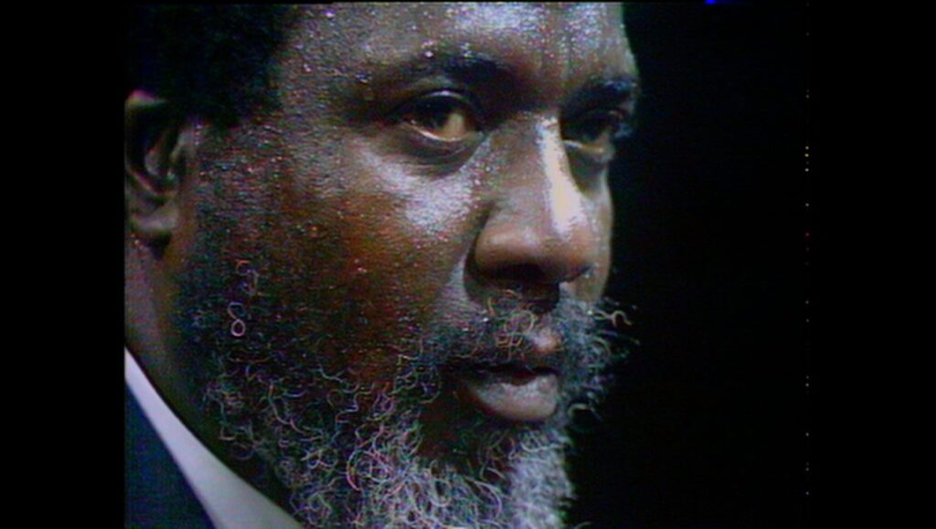 Rewind and Play — Alain Gomis Berlin Film Festival: Close-up of a man with a beard. Rewind Play film still.